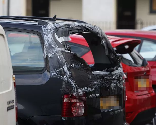 A car with a smashed rear window seen parked on Freehold last November