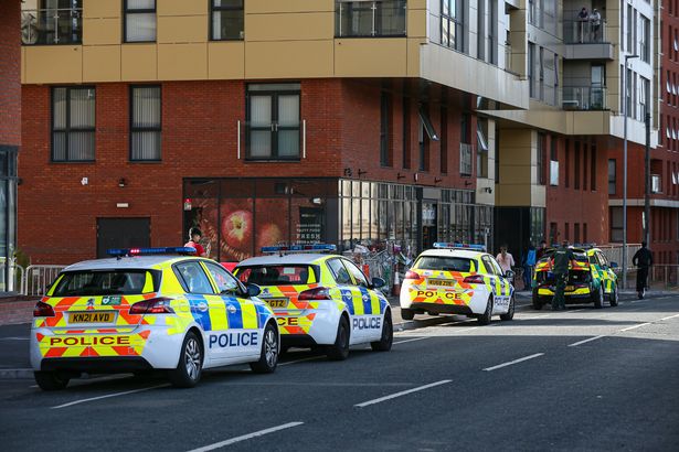 Police investigating the scene in Adelphi Street during the inquest