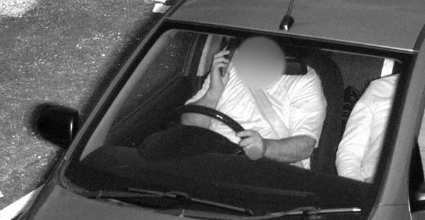 A driver using a mobile phone while driving