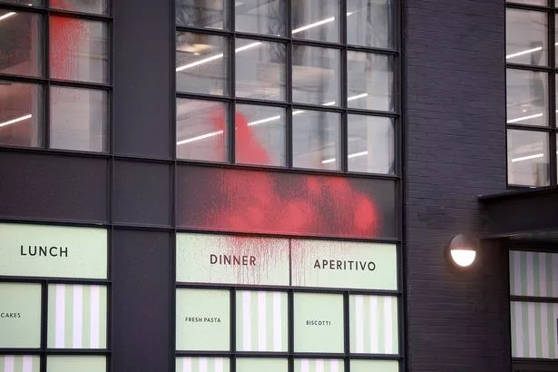 Windows covered in red paint after vandalism