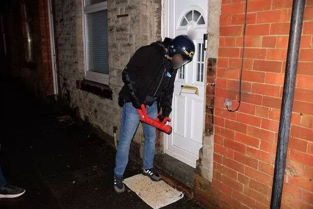 Officers force entry to a house during a fraud investigation