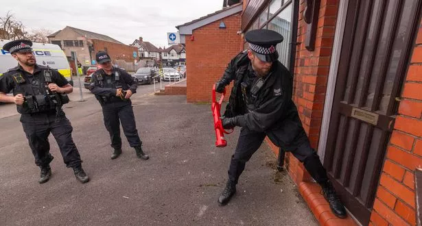 Officers from Greater Manchester Police conducting a warrant at a cannabis farm in Cheadle Hulme.