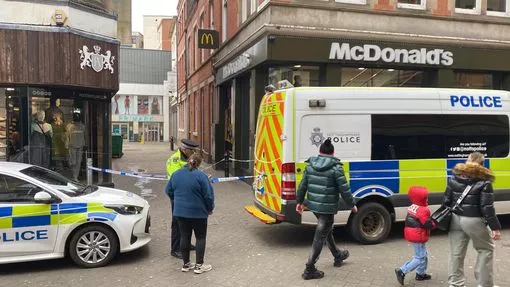 Police cordoning off the Primark store's entrance.